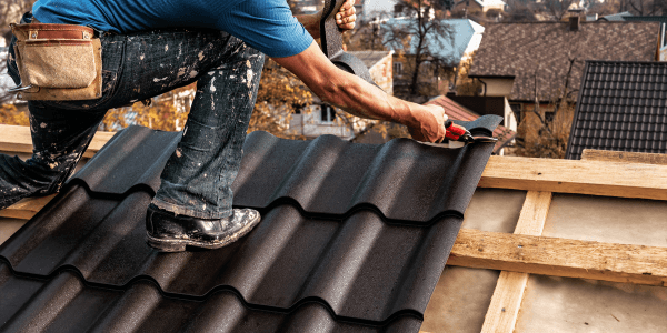 man repairing the roof with common types of roof repairs