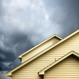 roof peak and siding of house under storm